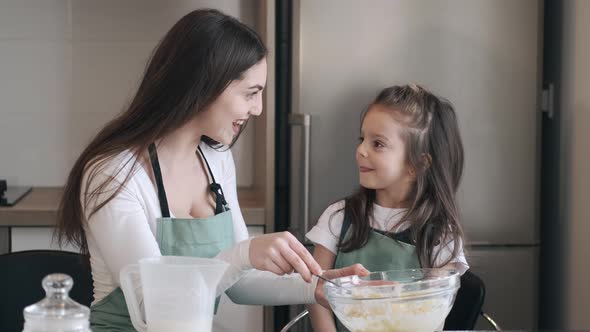 Beautiful Mother and Daughter Are Cooking Together