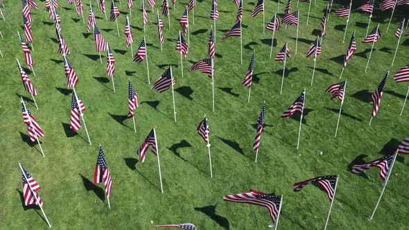 Slowly flying over American flags blowing in the wind