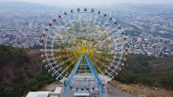 Ferris Wheel On The Mountain Over The City Aerial
