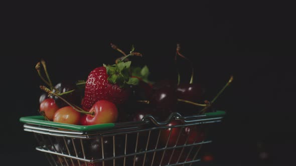 Red Fresh Strawberries and Cherries in a Little Trolley From a Super Layout