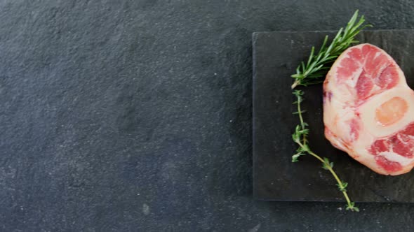 Sirloin chops and rosemary on chopping board