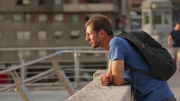 Tourist Standing on Bridge, Enjoying City View, Young Man on a Sightseeing Tour