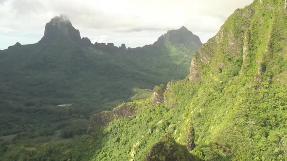 Aerial parallax shot revealing a stunning mountain range in Mo'orea island, French Polynesia