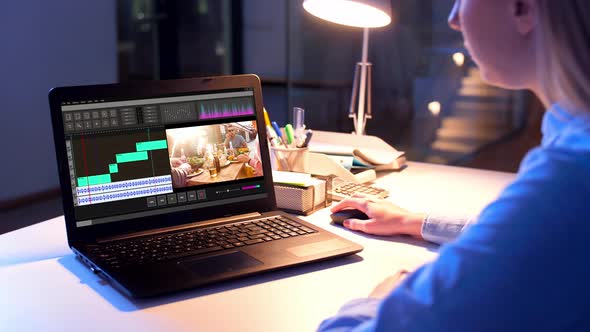 Editor Working on Video File on Laptop at Night 