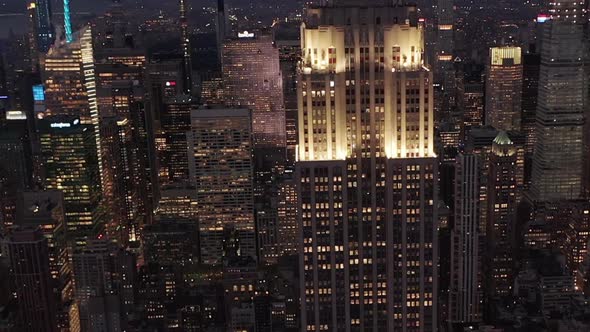 AERIAL: Looking Down on Beautiful Manhattan at Night Surrounded By Skyscrapers in Busy City in 