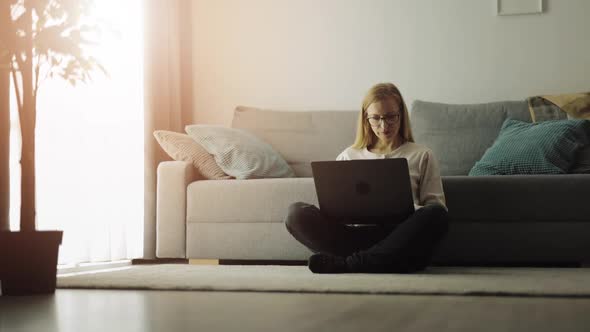 Woman Using Laptop at Home