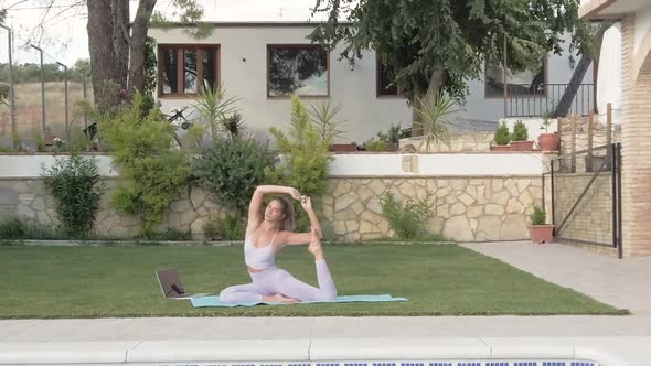 Flexible woman doing yoga in King Pigeon pose