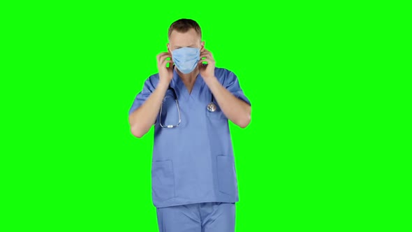 Doctor Puts a Medical Bandage on Face. Green Screen