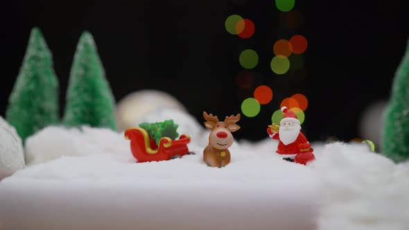 Toy Santa Claus on the Background of Light Bulbs