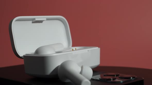 White Wireless Headphones on a Pink Background