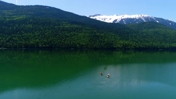 People kayaking in lake 4k