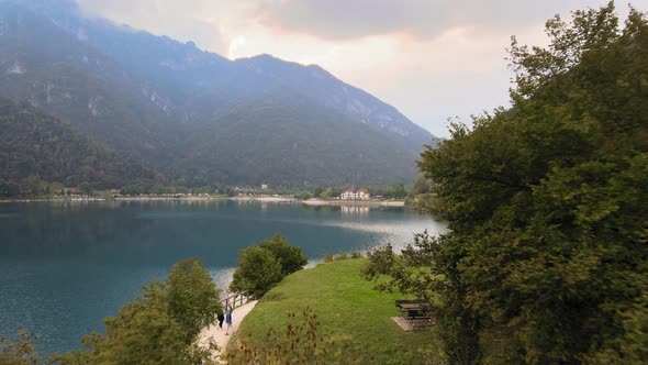 Aerial view on resting area and hiking path on shore of Lake Ledro, Italy