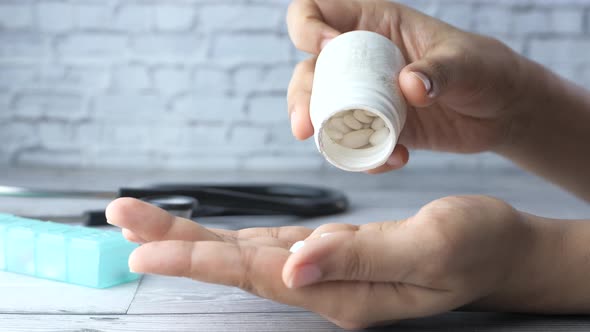 Close Up of Women Hand Taking Pills 