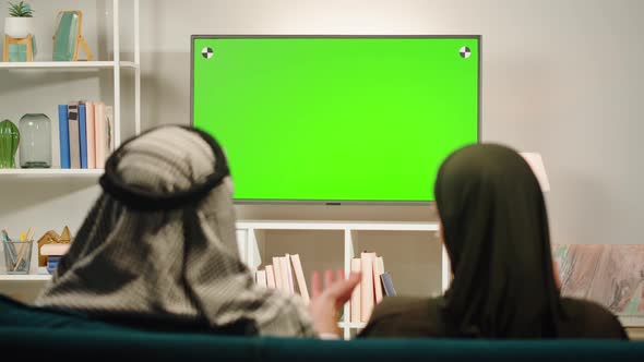 Middle Eastern Family Watching Tv with Chroma Key Closeup alt
