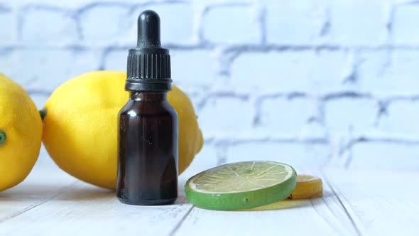 Close Up of a Bottle of Oil and Lemon on Table with Copy Space