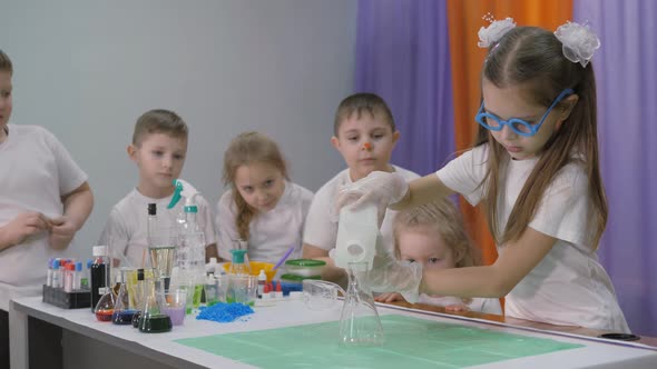 Chemical Experiments for Children, Girl Pours Ingredients Into a Transparent Dish, Bright Emotions