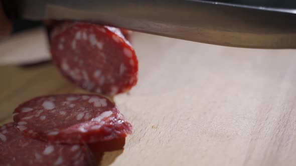 Hand Expert Cuts Parma Seasoned Salami, Thinly Sliced with a Knife and Emanates the Taste and the