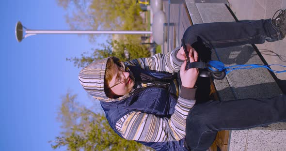 Smartphone Addiction Concept Teenage Boy with Smartphone and Headphones He Chatting with Friends