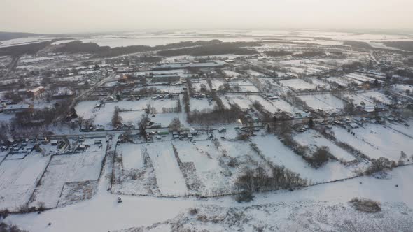 View From a Drone to the Ground Covered with Snow at the Morning