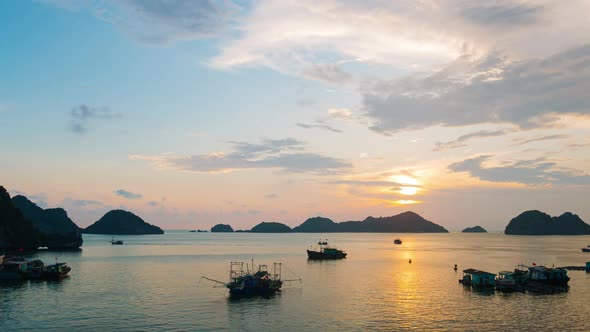 Time lapse: Vietnam Cat Ba bay at sunset with floating fishing boats on sea, cloudscape 