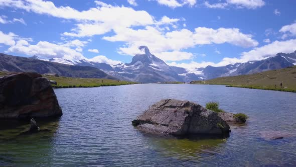 Aerial travel drone view of Zermatt at the Stellisee Lake, Mount Matterhorn, Switzerland.