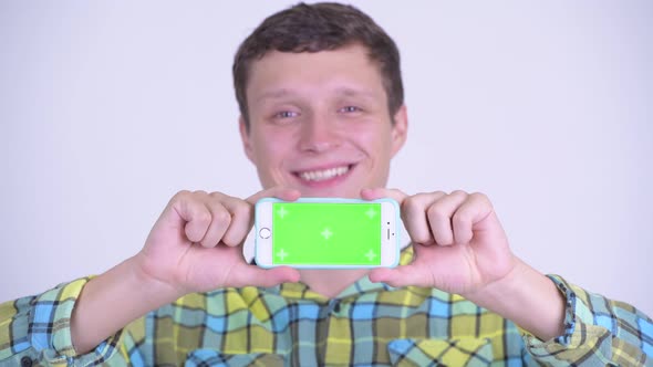 Face of Happy Young Handsome Man Showing Phone