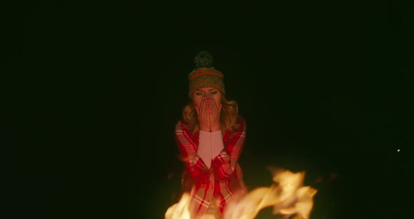 Woman Feeling Cold on Autumn Night. Handsome Tourist Warming Hands By Campfire