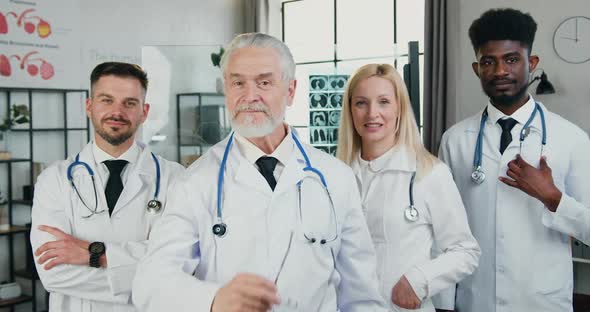 Different Ages Male and Female Doctors Standing in Front of Camera