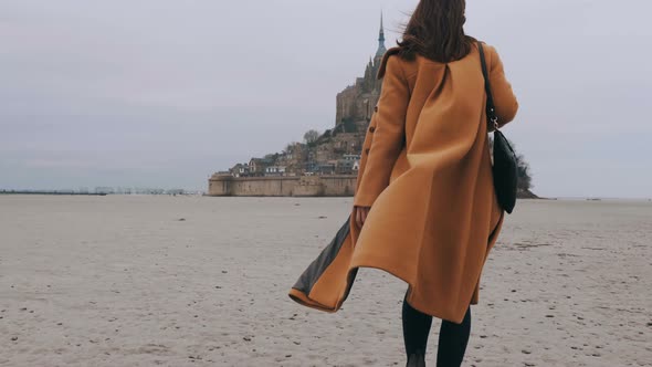 Medium Rear View Shot, Elegant Happy Blogger Woman Walks on Sea Bottom Sand at Epic Mont Saint