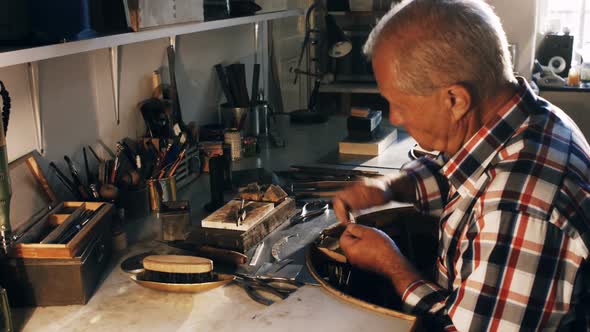 Goldsmith working in workshop