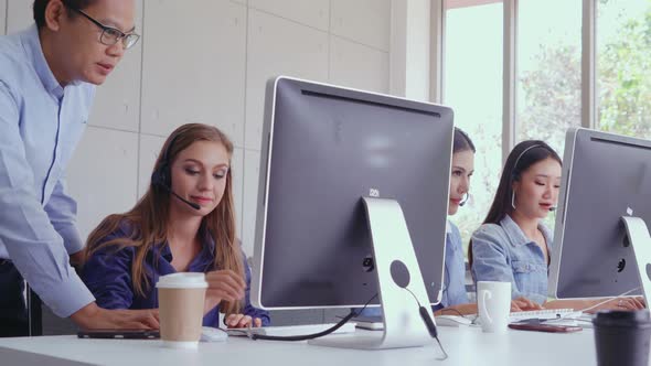 Customer Support Agent or Call Center with Headset Talking to Customer on Phone