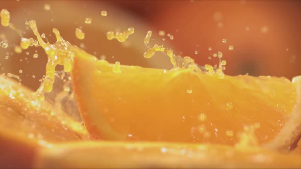 Slow Motion Shot of Orange Juice Splashing Through Orange Slices at 1400Fps