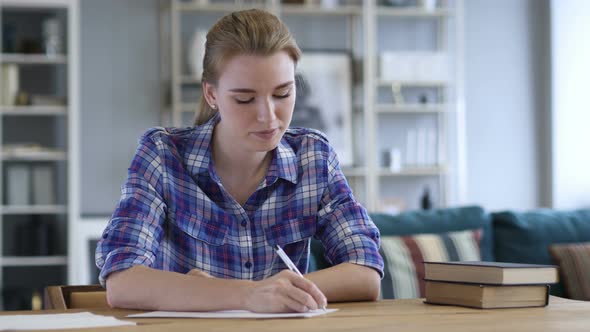 Paperwork, Young Woman Writing while Sitting on Desk