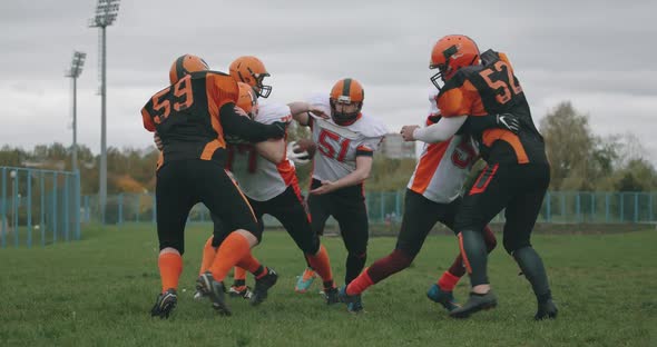 American Football Football Team in the Game Training Aggressive Opposition During the Game the Fight