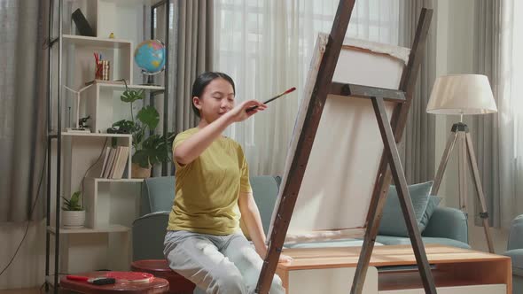 Asian Artist Girl Holding Paintbrush Wipe The Sweat Before Crossing His Arms And Smiling