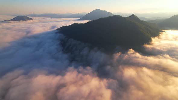 A sea of clouds above the valley and the mountains in the background