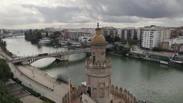 Drone orbit around historic Torre del Oro watchtower, Seville, Spain