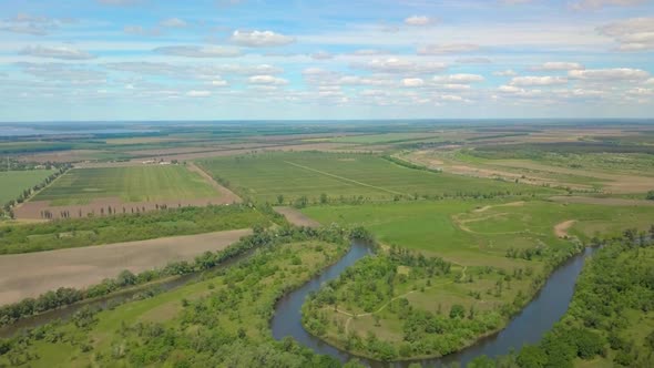 Flight Over Green Meadow, Forest and River in Spring