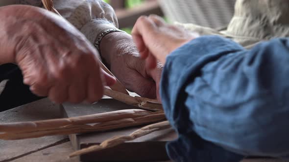 Two People Weaving Water Hyacinth