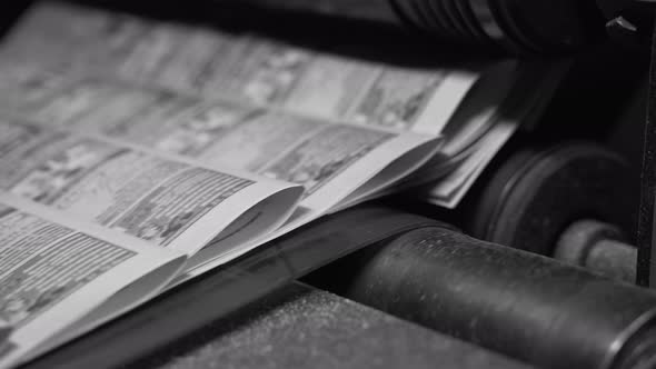 Printed Paper Newspapers Move Along the Conveyor One After Another