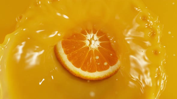 Super Slow Motion Shot of Orange Slice Splashing To Orange Juice at 1000Fps.