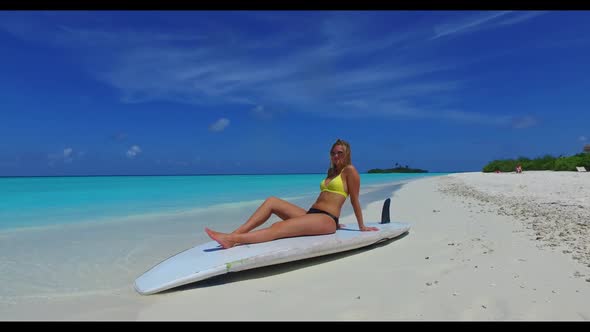 Ladies together happy together on tranquil coastline beach voyage by aqua blue lagoon with white san