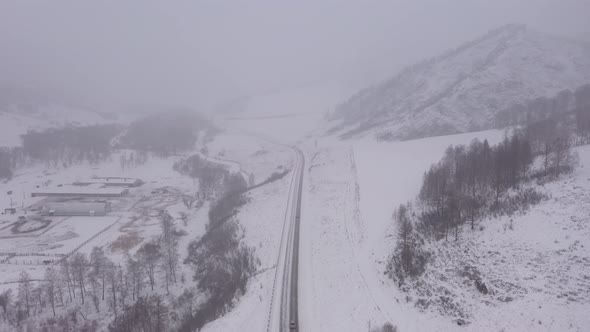 Flying Over Road in Winter in Foggy Weather Conditions