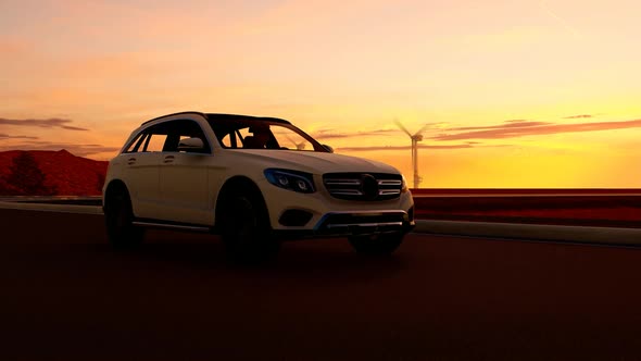 White Luxury SUV Sunset View and Wind Turbines