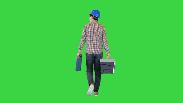 A Manual Worker with a Toolbox Walking on a Green Screen Chroma Key