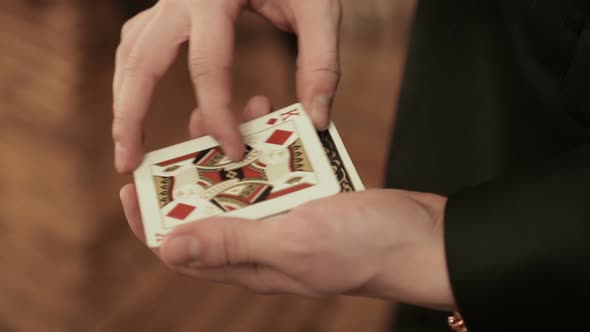 Closeup of a Magician's Hands Performing Card Trick