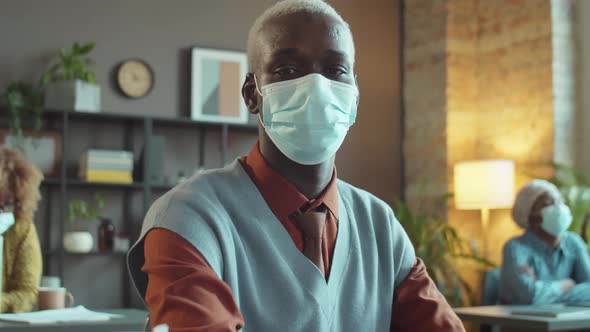 Portrait of African American Businessman in Mask at Work