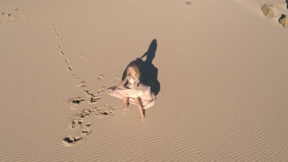 Drone Over Blond Woman In Ballgown On Beach