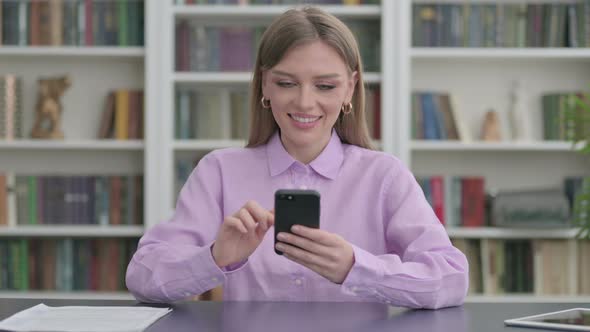 Woman Using Smartphone in Office