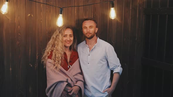 Hetero Couple Portrait by Wooden Wall